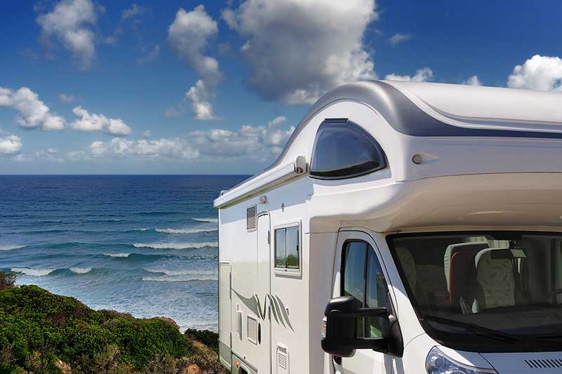 Camper vehicle parked by the beach after passing thorough rv inspection services