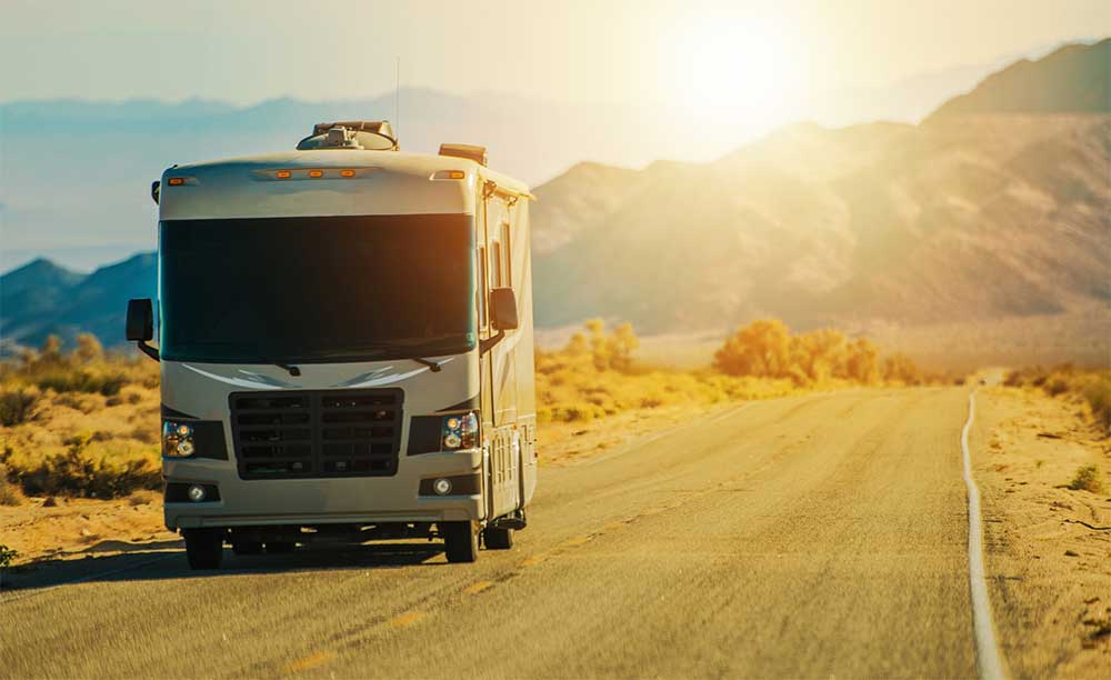 Motorhome driving through a desert mountain road after an rv inspection