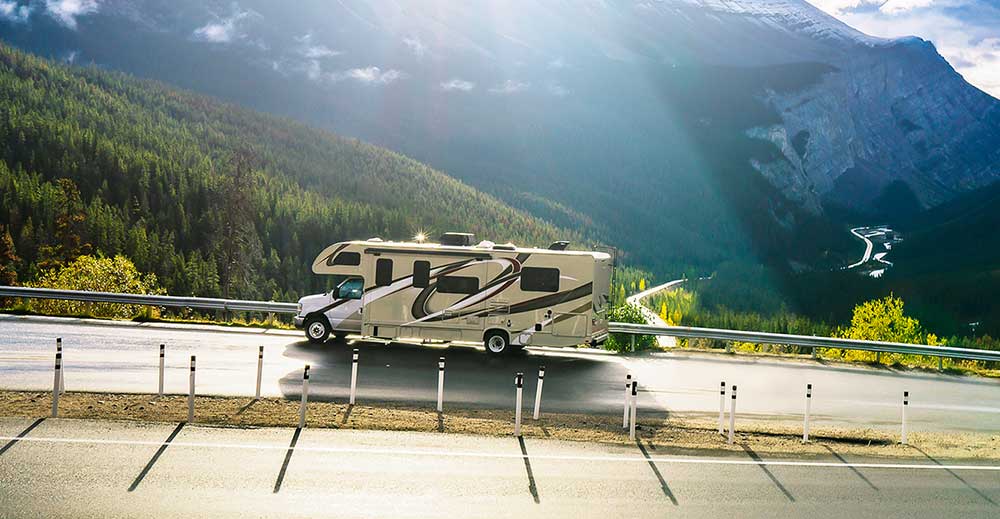 New motorhome parked by a mountain view after thorough RV inspection services