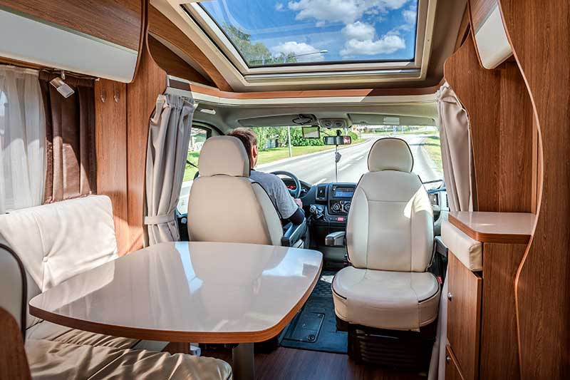 Interior view of a person driving a rental motorhome after rv inspection services were preformed