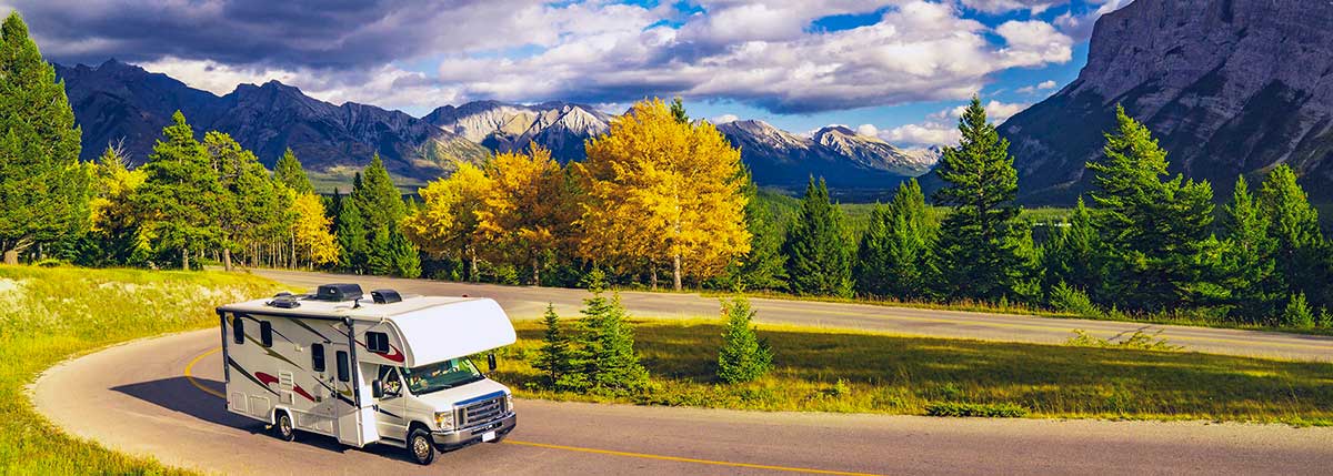 Motorhome Camper On Scenic Highway With Mountain Views After An RV Inspection